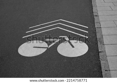 Marking for cyclists on an urban asphalt road, a white bicycle sign
