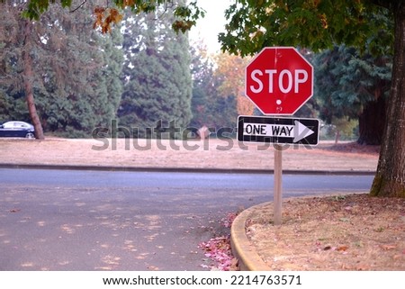 Stop and one way sign in the park