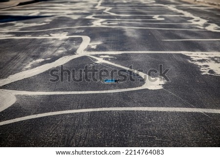 Street prepared for asphalt slurry resurfacing  Royalty-Free Stock Photo #2214764083