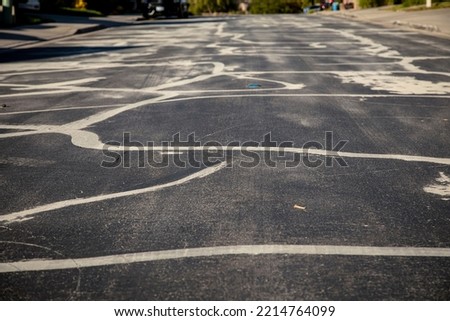 Street prepared for asphalt slurry resurfacing  Royalty-Free Stock Photo #2214764099