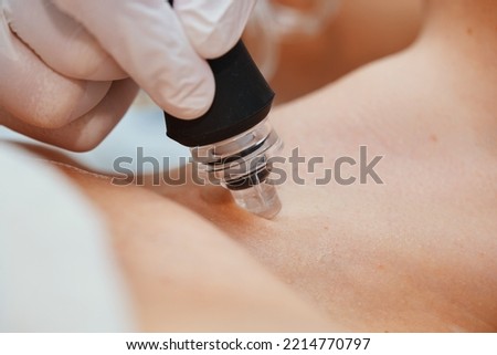 A cosmetologist performs hydropiling in a beauty salon. Skin care. High quality photo