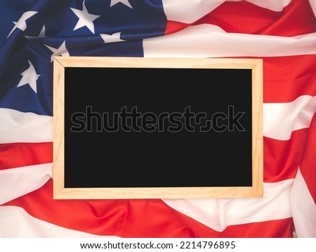 Top view of a mini chalkboard over the American flag background. Space for text