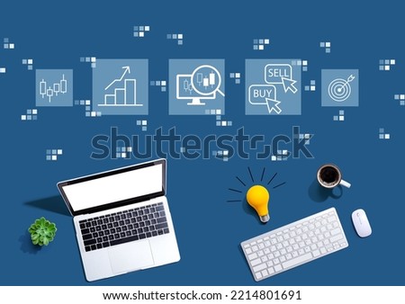Stock trading theme with computers with a light bulb from above