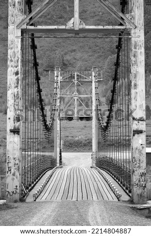 Orokto bridge on the Katuni River. Portal supports of a suspension bridge on the banks of a mountain river. Altai Republic, Siberia, Russia, 2022