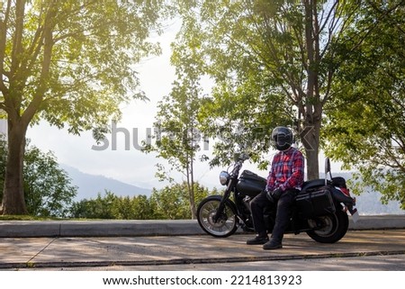 Man on the side of the road with his motorcycle