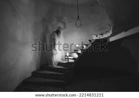 Ghost in abandoned, haunted house. Horror scene of spooky silhouette holding old axe, halloween concept.