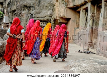 The Ajanta Caves india are a very Famous in world.traditional  women visitors  excting to see it. Royalty-Free Stock Photo #2214834897