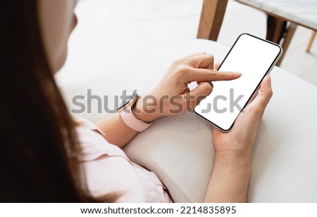 Mockup woman hand holding the black smartphone with blank white screen. Business and technology concept. Clipping path. Royalty-Free Stock Photo #2214835895