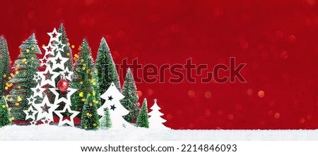 Many christmas trees with snow and wooden trees with red bauble. Merry Christmas and a Happy New Year banner with borders. Seasons greetings card. Red background