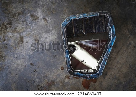 Old used car automatic transmission oil pan. Royalty-Free Stock Photo #2214860497