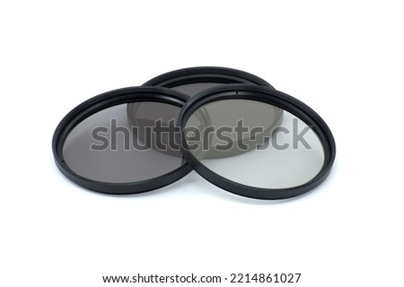 Set of screw-on photographic neutral density ND filters to reduce amount of light isolated on a white background