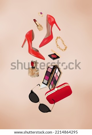 Flying fashion accesories on golden background Royalty-Free Stock Photo #2214864295