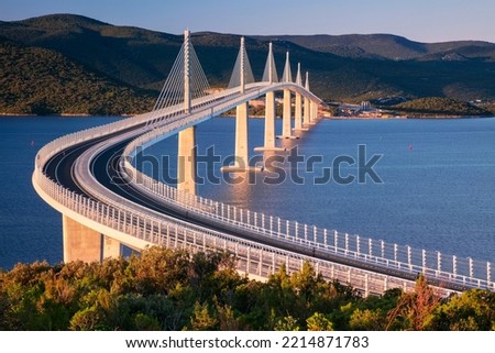 Peljesac Bridge, Croatia. Image of beautiful modern multi-span cable-stayed Peljesac Bridge over the sea in Dubrovnik-Neretva County, Croatia at sunrise. Royalty-Free Stock Photo #2214871783