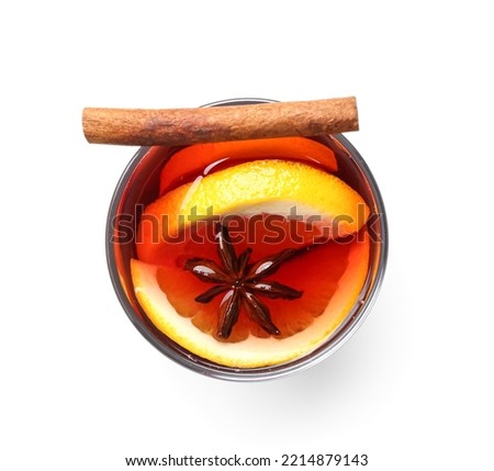 Glass of aromatic mulled wine on white background