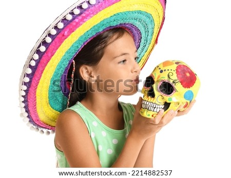 Cute little girl in sombrero hat with painted human skull on white background