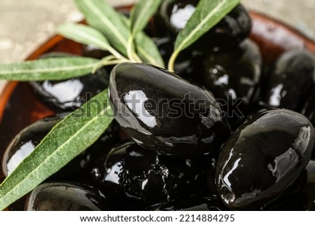 Bowl of tasty black olives, closeup