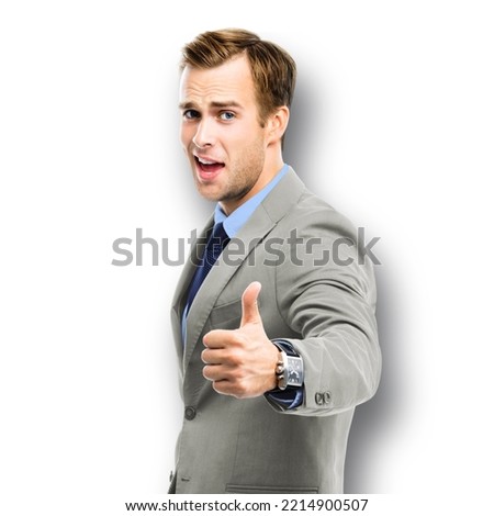 Portrait of happy confident businessman in grey suit, blue shirt and tie, isolated on white background. Business success concept. Smiling man at studio picture.
