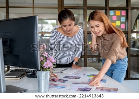 Photographer and graphic designer working in office creating team discussing ideas in advertising agency.