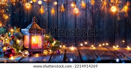 Christmas Lantern Glowing On Wooden Table With Decoration And String Lights - Bokeh And Glittering Effect On Background