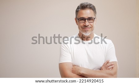 Portrait of happy casual older man smiling, Mid adult, mature age guy with gray hair in glasses, Isolated on white background, copy space. Royalty-Free Stock Photo #2214920415
