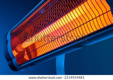 Modern electric infrared heater in the living room Royalty-Free Stock Photo #2214924483
