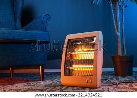 Modern electric infrared heater in the living room Royalty-Free Stock Photo #2214924521