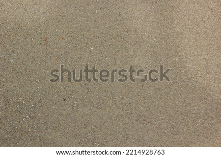 Beach wet coarse brown sand Texture for background.