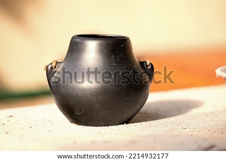 black clay pot sunny day horizontal