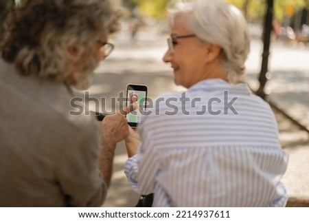 senior couple tourists use the smartphone map app to locate their destination