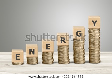 Stack of coins and wooden blocks with energy text