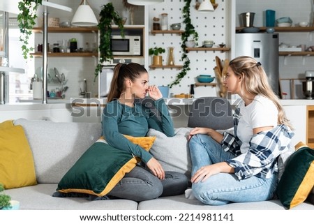 Young women lesbian couple LGBTQ+ roommates having argue due the infidelity and cheating. Two girls in relationship having difficulty caused by jealousy. Marriage problems concept. Royalty-Free Stock Photo #2214981141