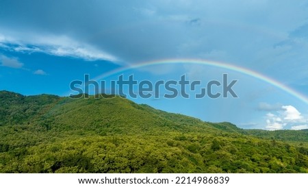 Rainbow on Sky in the mountains, Panorama of flying in a Nature rainbow in the rain, aerial view of Rainbow in mountain , Rainbow in the Mountains Puffy Clouds After the Rain
