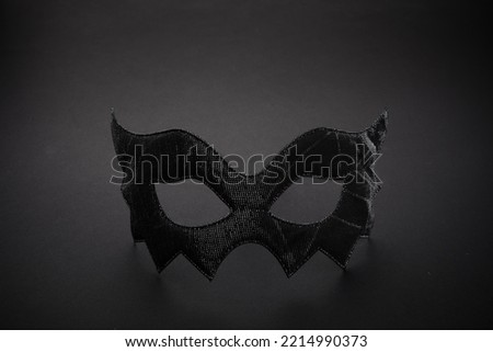 A bat-shaped mask on a black background for Halloween