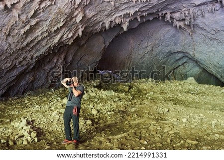 Nature photographer shooting in a cave underground