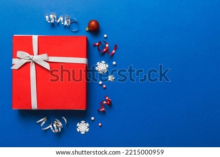 Top view Flat lay Christmas decorations and gift box on colored background with copy space. Christmas or Happy New Year composition.