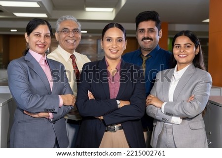 Successful group of business people at the office looking at the camera smiling.
