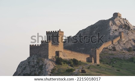 footage over the Genoese fortress in Sudak, Crimea at sunset. Royalty-Free Stock Photo #2215018017
