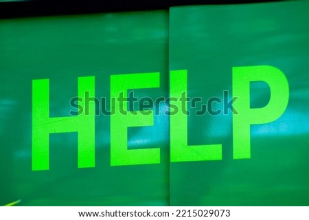 Green metal surface displaying "help" text
