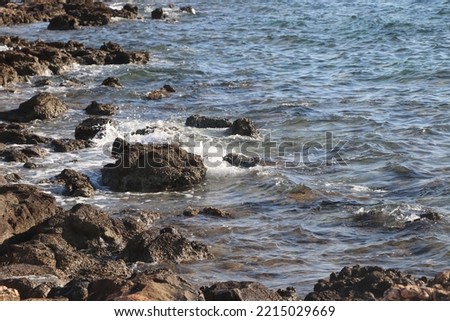 Photo of waves hitting rocks