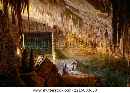 
Flowstone cave Cuevas Drach (Cuevas Coves) at Mallorca Island, Spain, with stalactites at ceiling and stalagmite on the floor on an autumn day. Photo taken 11th October, 2022, Mallorca Island, Spain.