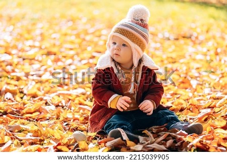 little fashionable and stylish child autumn park