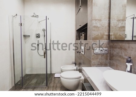 Modern bathroom in white and gray tones with mosaic on wide angle view. Real estate concept. Royalty-Free Stock Photo #2215044499