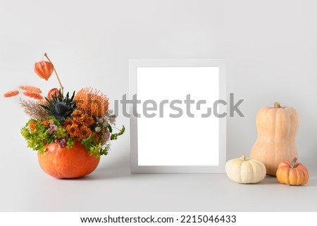Autumn mockup with flowers bouquet in pumpkin, decor elements and white frame on white background. Copy space. Fall template.