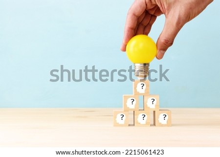 Education and human resource concept image. Creative idea and innovation. light bulb metaphor over blue background, wooden cubes and people icons