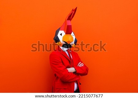 Cool man wearing 3d origami mask with stylish colored clothes - Creative concept for advertising, animal head mask doing funny things on colorful background