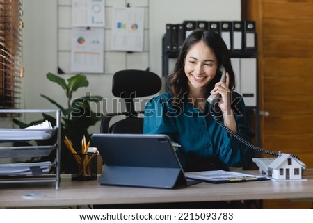 Home loan contract. house model on workplace desk with real estate agent professional making business call talking on phone with customer for signing rental lease contract in office concept