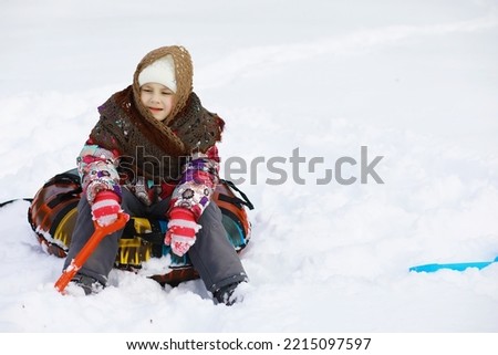 Traditional Russian holiday in early spring. Seeing off winter. Mardi gras. Family with children in winter in the park.