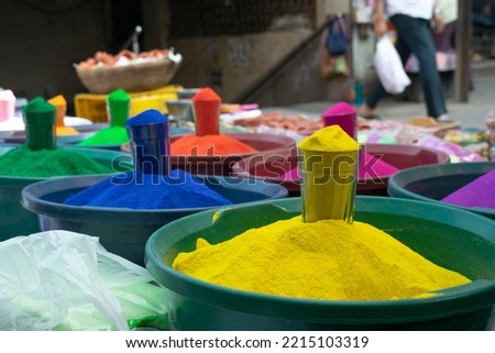 Vibrant colors, rangoli, dyes in glass and tubs on street for sale during festivals of Holi, Diwali. Colorful, lakshmi, handmade, organic, home entrance, drawing, chemical, apply, rangpanchmi, water Royalty-Free Stock Photo #2215103319