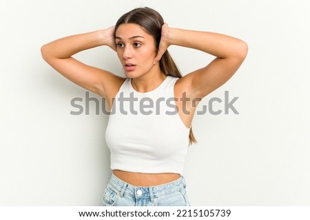 Young Indian woman isolated on white background screaming, very excited, passionate, satisfied with something.