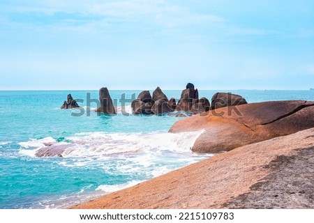 Seascape. Large stones are washed by blue sea waves. Wallpaper on the screen, picture.